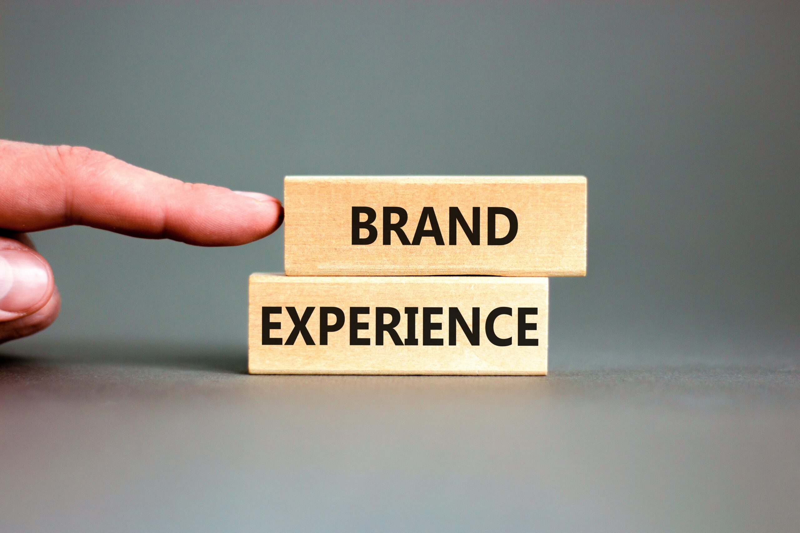 Two wooden blocks with "brand" and "experience" written on it.