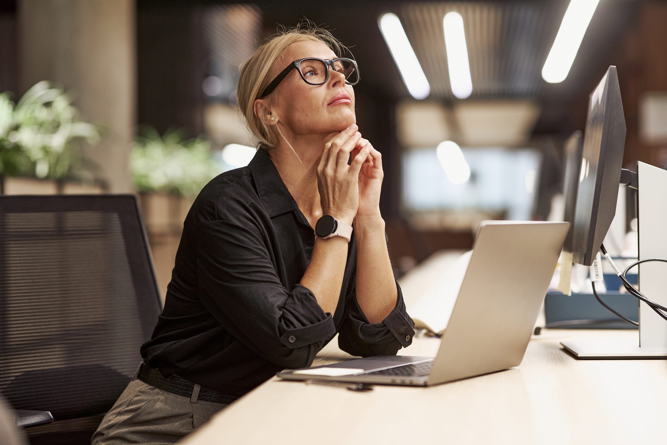 A female employee thinking about career opportunities.