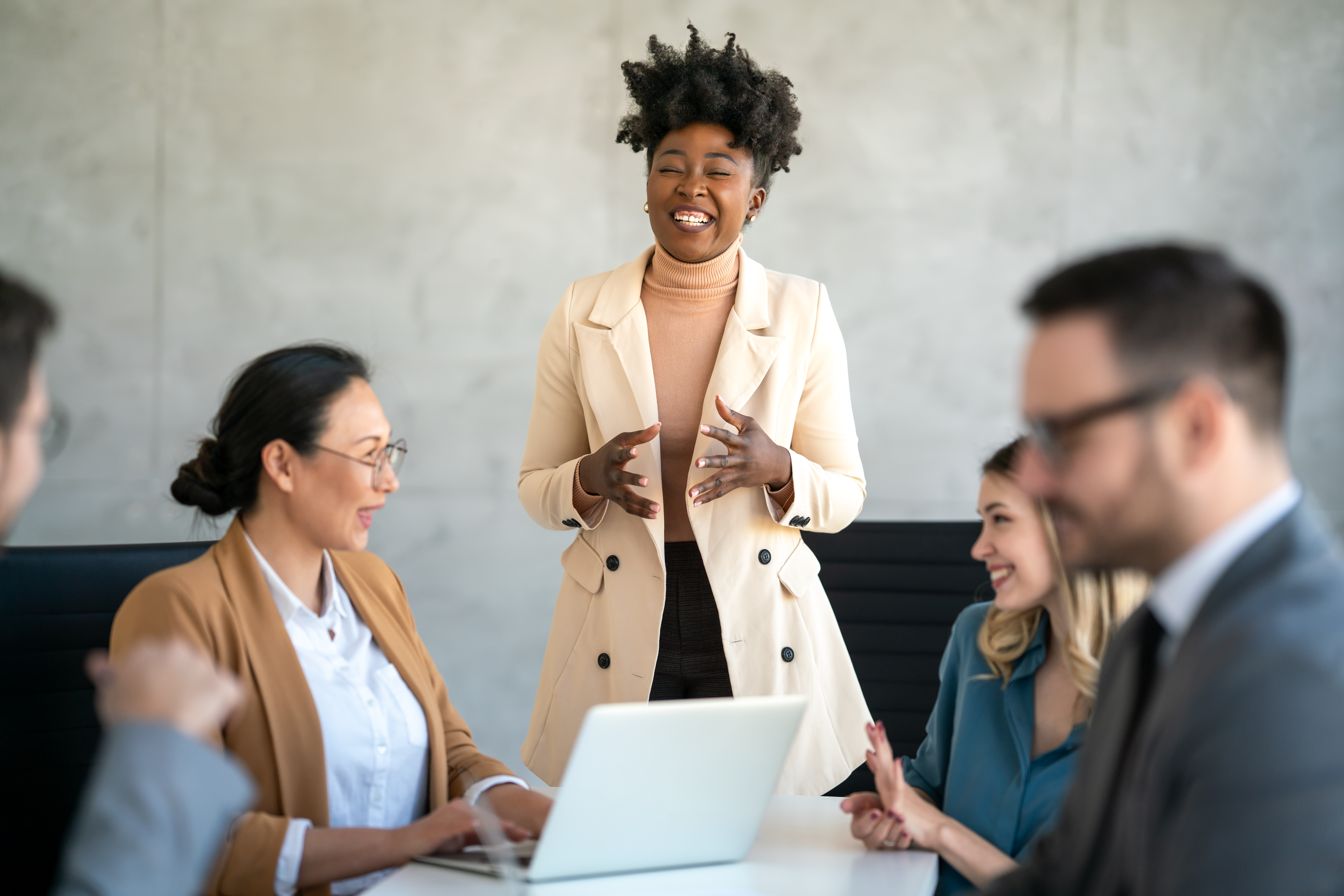 A female manager leading her team in a team meeting.